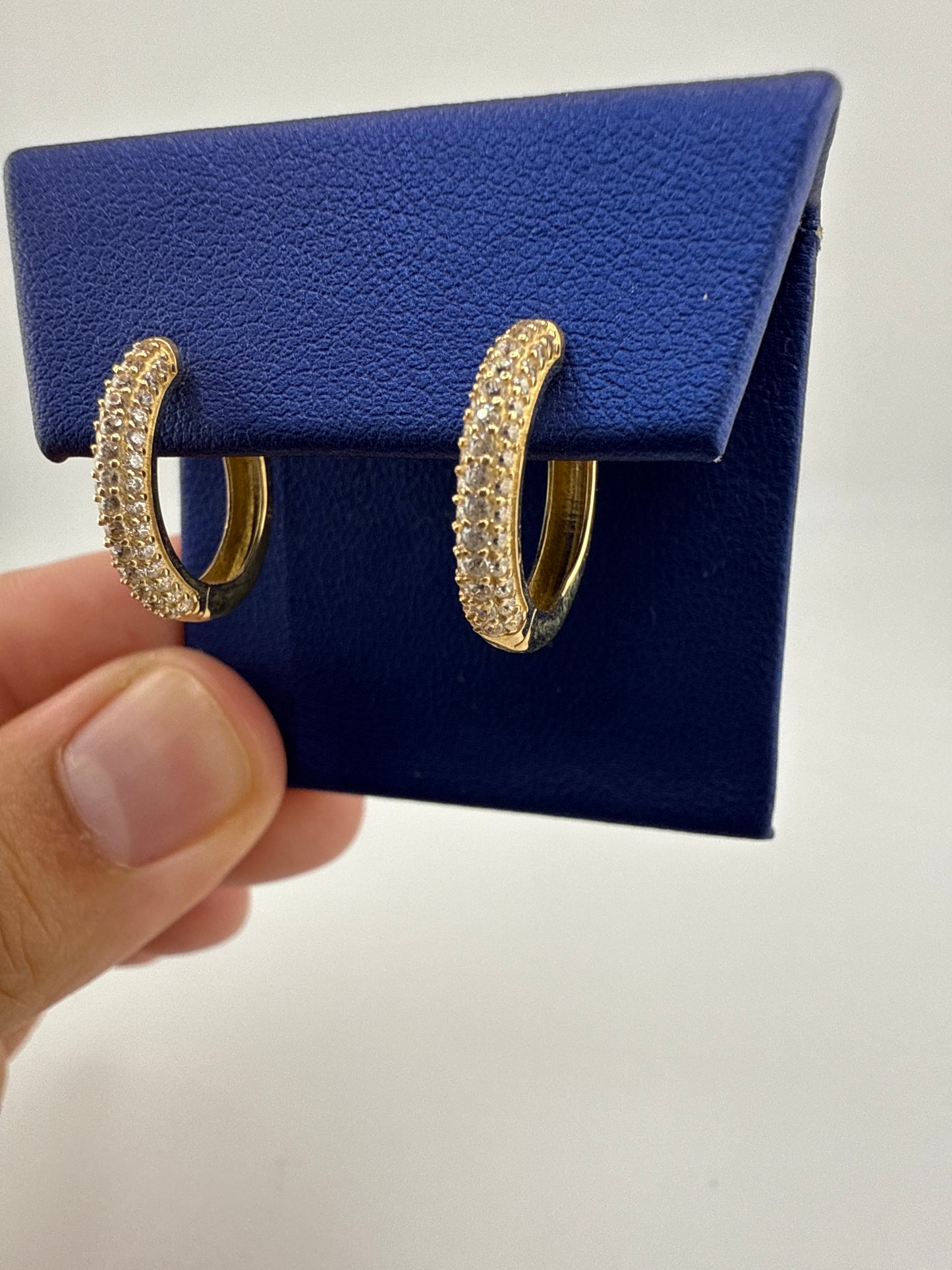 14k yellow gold huggie earrings with zirconia