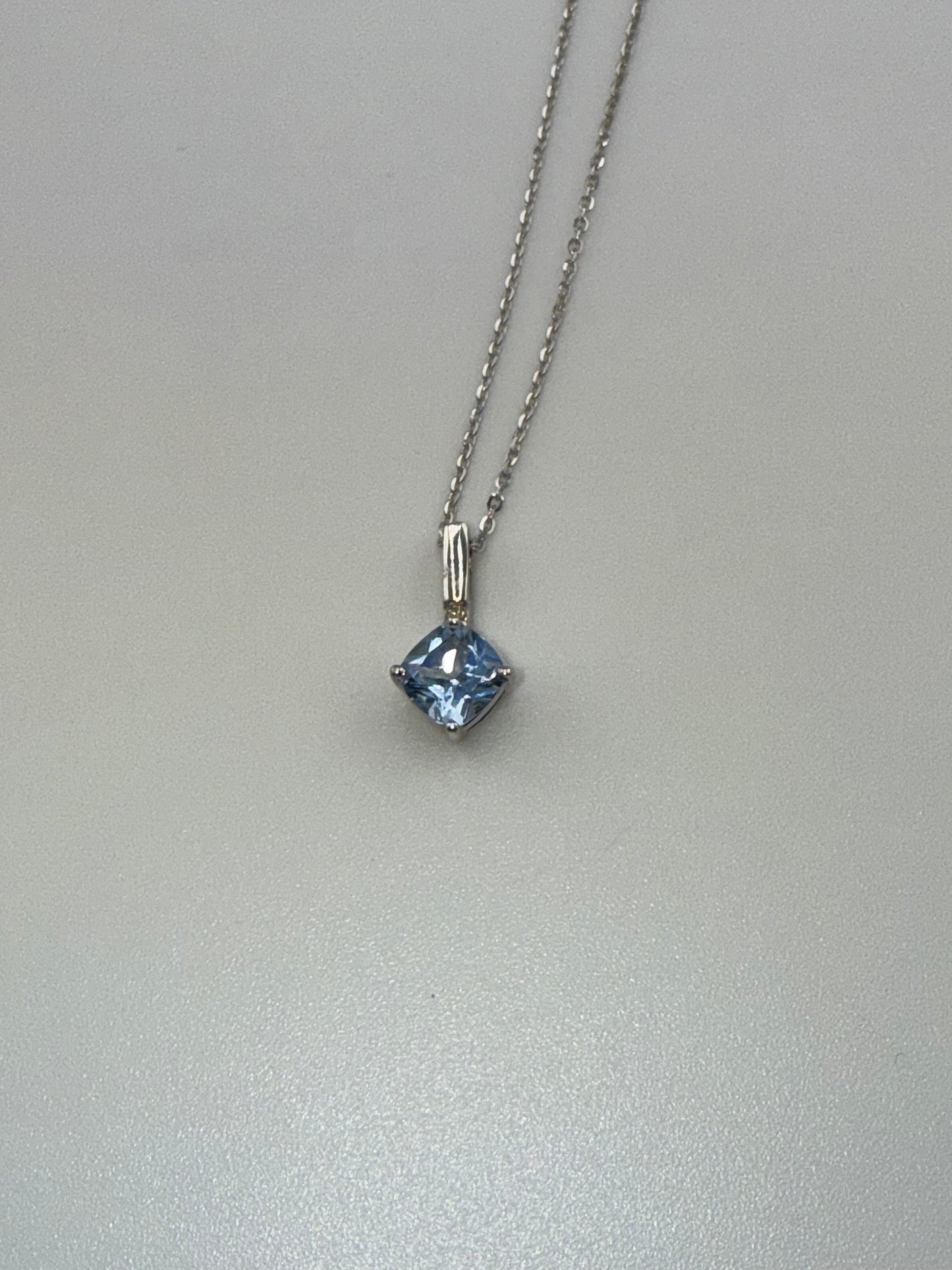 14k white gold chain and light blue gemstone pendant