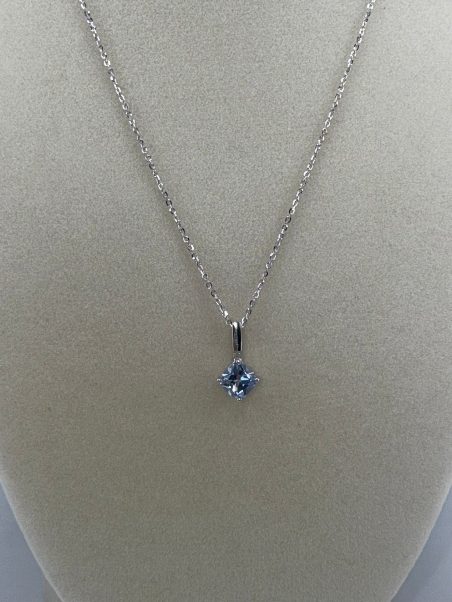 14k white gold chain and light blue gemstone pendant