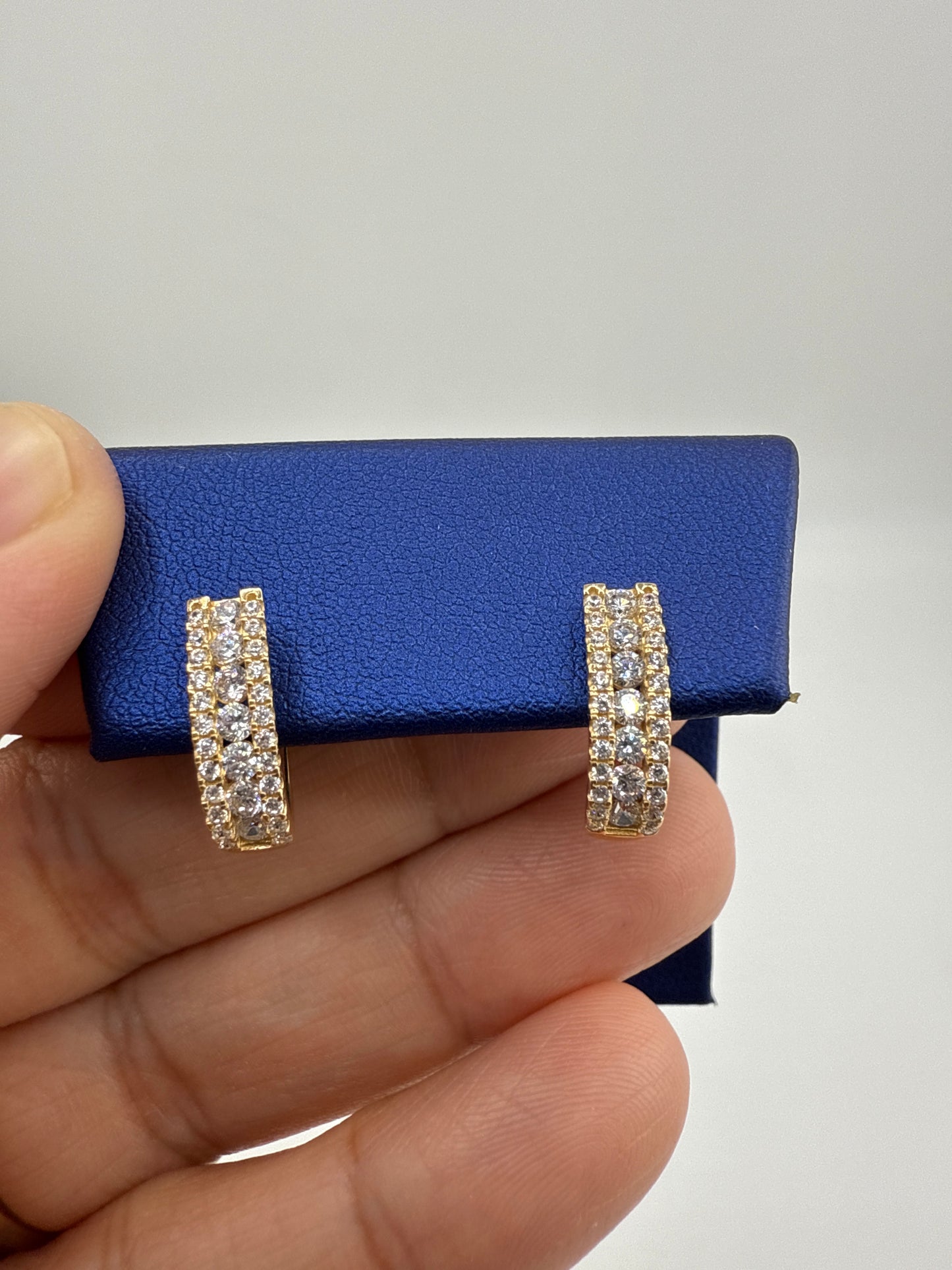 14k yellow gold huggie earrings with zirconia